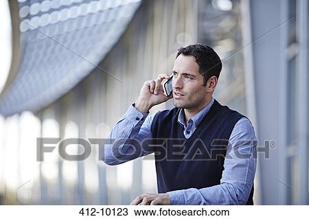 Businessman talking on cell phone outdoors View Large Photo Image Stock Image - Businessman talking on cell phone outdoors. Fotosearch
