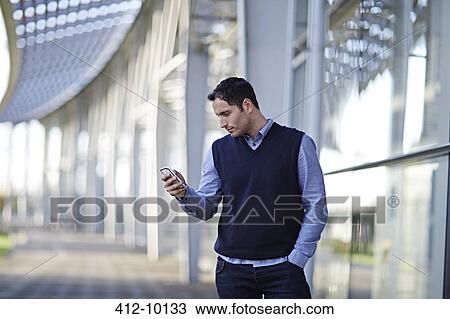 Businessman using cell phone outdoors View Large Photo Image Stock Image - Businessman using cell phone outdoors. Fotosearch