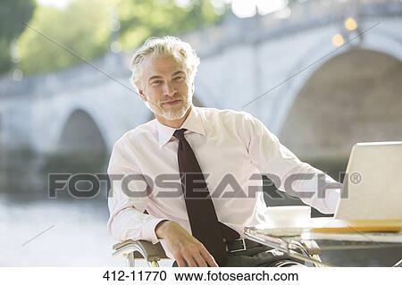 Businessman working at sidewalk cafe View Large Photo Image Stock Image - Businessman working at sidewalk cafe. Fotosearch