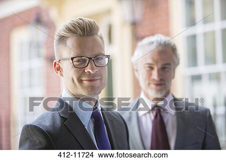 Businessmen smiling on city street View Large Photo Image Picture - Businessmen smiling on city street. Fotosearch