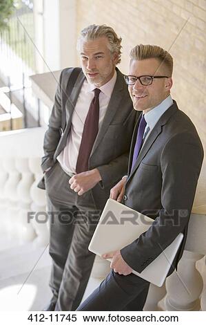 Stock Photography - Businessmen smiling on outdoor steps. Fotosearch