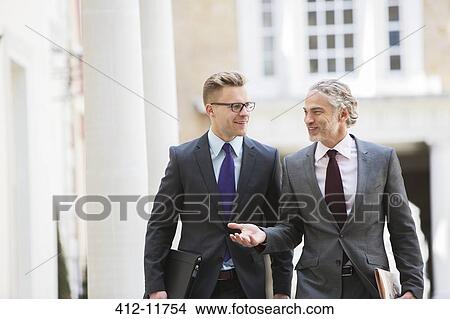 Picture - Businessmen talking outdoors. Fotosearch