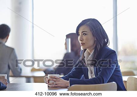 Businesswoman drinking coffee in cafe View Large Photo Image Stock Photograph - Businesswoman drinking coffee in cafe. Fotosearch