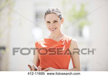 Businesswoman holding digital tablet View Large Photo Image Stock Photography - Businesswoman holding digital tablet. Fotosearch