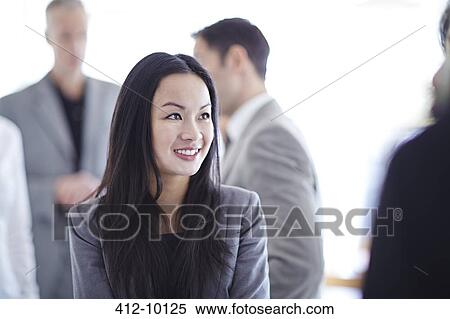 Businesswoman smiling in office View Large Photo Image Stock Photography - Businesswoman smiling in office. Fotosearch