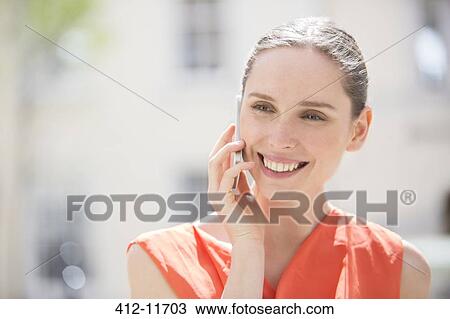 Businesswoman talking on cell phone outdoors View Large Photo Image Stock Image - Businesswoman talking on cell phone outdoors. Fotosearch