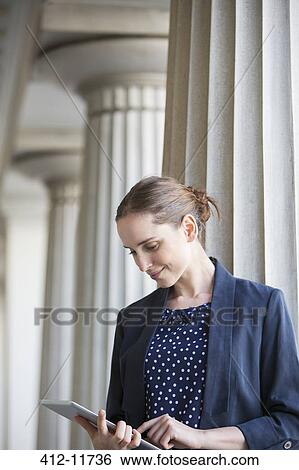 Businesswoman using digital tablet outdoors View Large Photo Image Stock Photograph - Businesswoman using digital tablet outdoors. Fotosearch