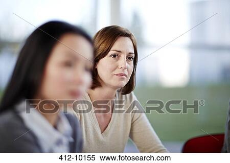 Businesswomen sitting in meeting View Large Photo Image Stock Photography - Businesswomen sitting in meeting. Fotosearch