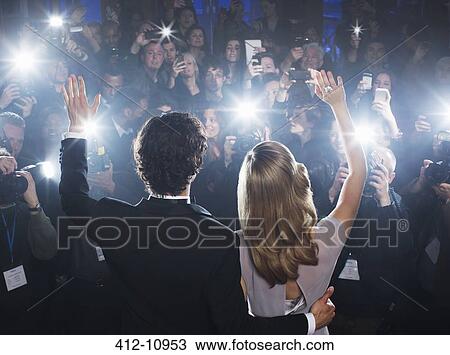 Celebrity couple waving to paparazzi at red carpet event View Large Photo Image Stock Image - Celebrity couple waving to paparazzi at red carpet event. Fotosearch
