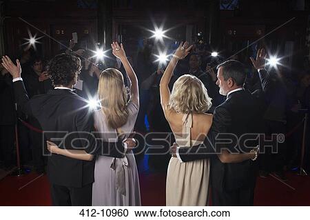 Celebrity couples waving to paparazzi on red carpet View Large Photo Image Stock Image - Celebrity couples waving to paparazzi on red carpet. Fotosearch