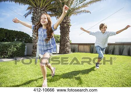 Children playing in backyard View Large Photo Image Stock Photograph - Children playing in backyard. Fotosearch