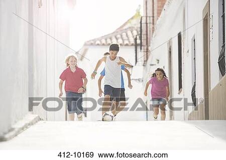 Children playing soccer in alley View Large Photo Image Stock Photo - Children playing soccer in alley. Fotosearch