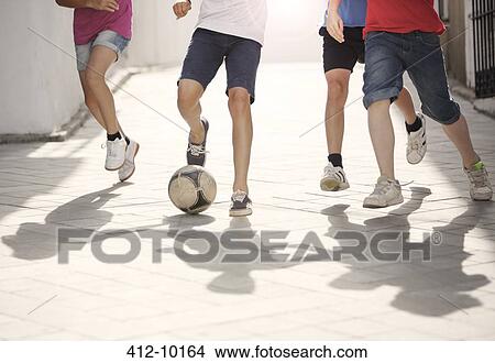 Children playing with soccer ball in alley View Large Photo Image Picture - Children playing with soccer ball in alley. Fotosearch