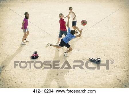 Children playing with soccer ball in sand View Large Photo Image Picture - Children playing with soccer ball in sand. Fotosearch