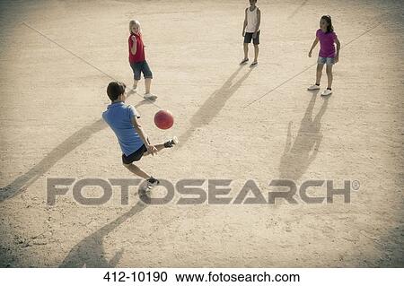 Children playing with soccer ball in sand View Large Photo Image Stock Image - Children playing with soccer ball in sand. Fotosearch