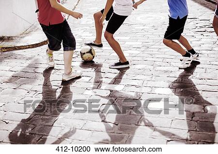 Children playing with soccer ball in alley View Large Photo Image Stock Image - Children playing with soccer ball in alley. Fotosearch