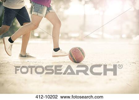 Children playing with soccer ball in sand View Large Photo Image Stock Image - Children playing with soccer ball in sand. Fotosearch