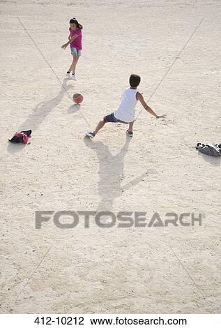 Children playing with soccer ball in sand View Large Photo Image Stock Image - Children playing with soccer ball in sand. Fotosearch