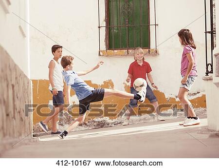 Children playing with soccer ball in alley View Large Photo Image Stock Photo - Children playing with soccer ball in alley. Fotosearch