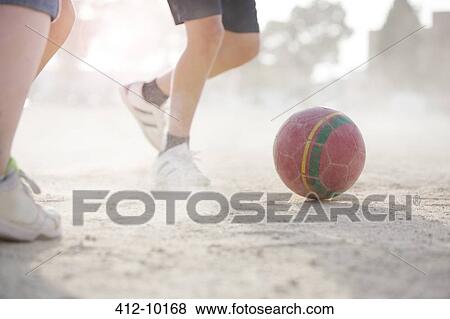 Children playing with soccer ball in sand View Large Photo Image Stock Photo - Children playing with soccer ball in sand. Fotosearch