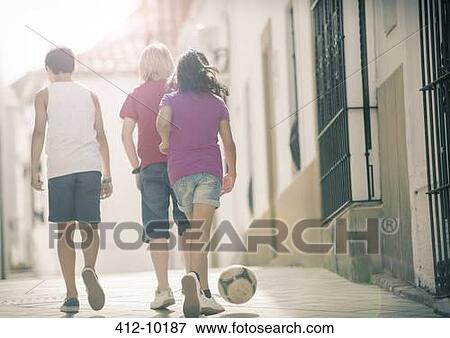 Children playing with soccer ball in alley View Large Photo Image Stock Photo - Children playing with soccer ball in alley. Fotosearch