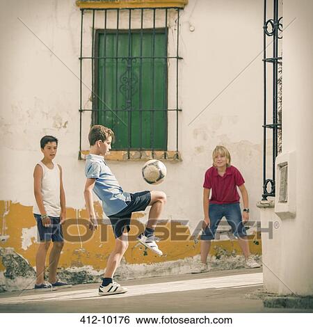 Children playing with soccer ball in alley View Large Photo Image Stock Photograph - Children playing with soccer ball in alley. Fotosearch