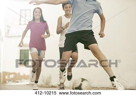 Children playing with soccer ball in alley View Large Photo Image Stock Photography - Children playing with soccer ball in alley. Fotosearch
