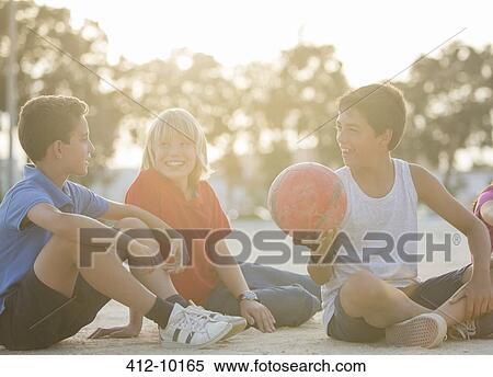 Children sitting with soccer ball outdoors View Large Photo Image Stock Photography - Children sitting with soccer ball outdoors. Fotosearch