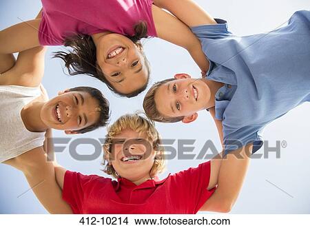 Children smiling in huddle outdoors View Large Photo Image Picture - Children smiling in huddle outdoors. Fotosearch