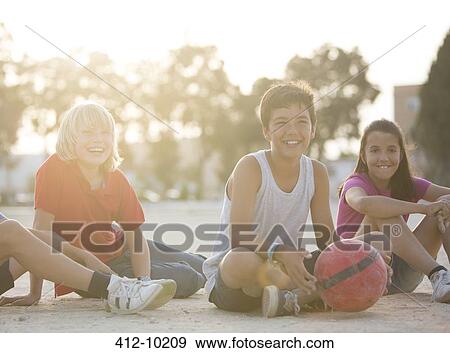 Children with soccer ball sitting outdoors View Large Photo Image Stock Photo - Children with soccer ball sitting outdoors. Fotosearch