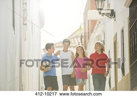 Children with soccer ball walking in alley View Large Photo Image Stock Photo - Children with soccer ball walking in alley. Fotosearch