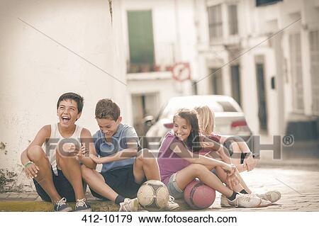 Children with soccer balls laughing on city street View Large Photo Image Stock Photo - Children with soccer balls laughing on city street. Fotosearch