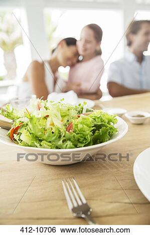 Close up of bowl of salad on table View Large Photo Image Stock Photograph - Close up of bowl of salad on table. Fotosearch