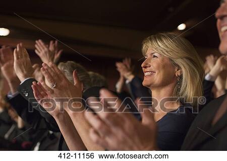 Close up of enthusiastic woman clapping in theater audience View Large Photo Image Stock Photograph - Close up of enthusiastic woman clapping in theater audience. Fotosearch