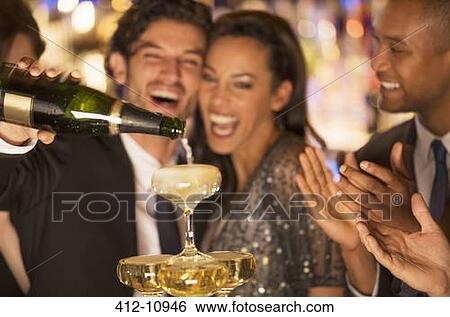 Close up of laughing couple pouring champagne pyramid View Large Photo Image Stock Photograph - Close up of laughing couple pouring champagne pyramid. Fotosearch