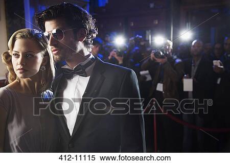 Close up of well dressed celebrity at red carpet event with paparazzi in background View Large Photo Image Stock Photography - Close up of well dressed celebrity at red carpet event with paparazzi in background. Fotosearch