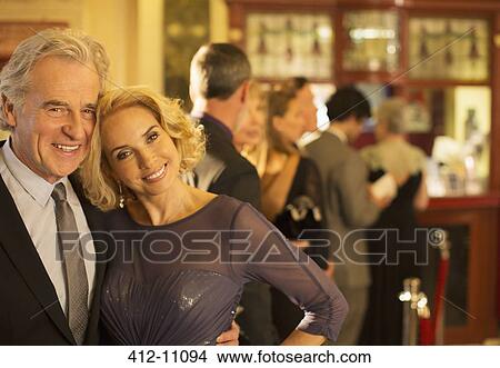Close up of well dressed couple smiling in theater lobby View Large Photo Image Picture - Close up of well dressed couple smiling in theater lobby. Fotosearch