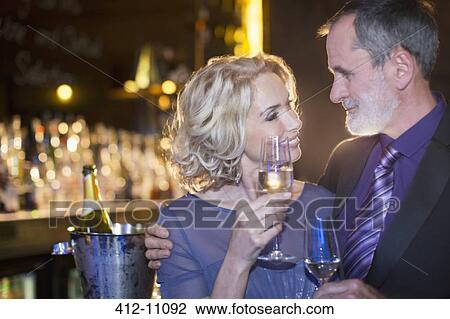 Close up of well dressed couple drinking champagne View Large Photo Image Stock Image - Close up of well dressed couple drinking champagne. Fotosearch