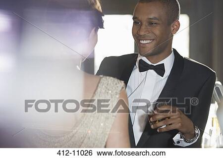 Close up of well dressed couple talking View Large Photo Image Stock Photograph - Close up of well dressed couple talking. Fotosearch