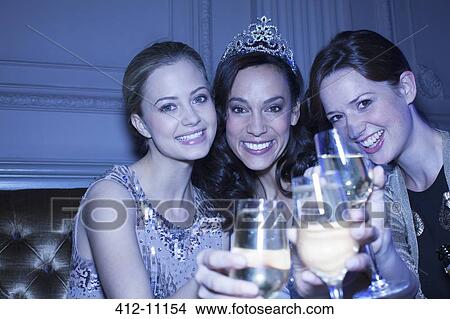 Close up of well dressed women toasting champagne flutes View Large Photo Image Picture - Close up of well dressed women toasting champagne flutes. Fotosearch