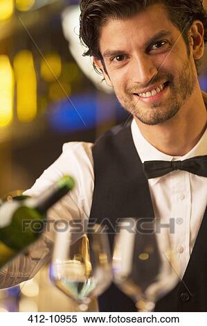 Close up portrait of well dressed bartender pouring wine View Large Photo Image Stock Photography - Close up portrait of well dressed bartender pouring wine. Fotosearch