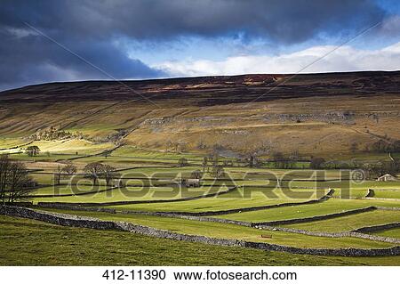 Stock Image - Clouds over rural hills. Fotosearch