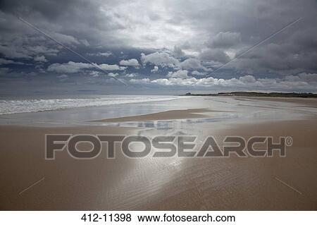 Clouds reflected in water on beach View Large Photo Image Stock Photo - Clouds reflected in water on beach. Fotosearch