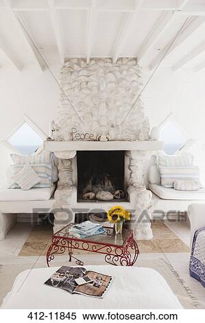 Stock Photography - Coffee table and fireplace in white living room. Fotosearch
