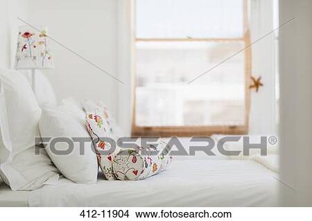 Colorful pillows on white bed View Large Photo Image Picture - Colorful pillows on white bed. Fotosearch