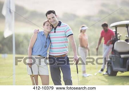 Couple hugging on golf course View Large Photo Image Stock Photo - Couple hugging on golf course. Fotosearch