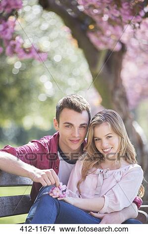 Couple hugging on park bench View Large Photo Image Picture - Couple hugging on park bench. Fotosearch