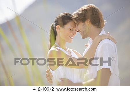 Couple hugging outdoors View Large Photo Image Stock Image - Couple hugging outdoors. Fotosearch