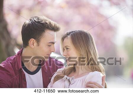 Stock Image - Couple hugging outdoors. Fotosearch