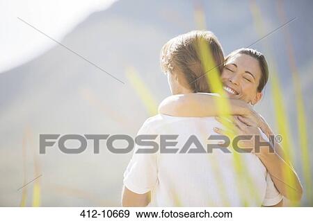Couple hugging outdoors View Large Photo Image Stock Photo - Couple hugging outdoors. Fotosearch